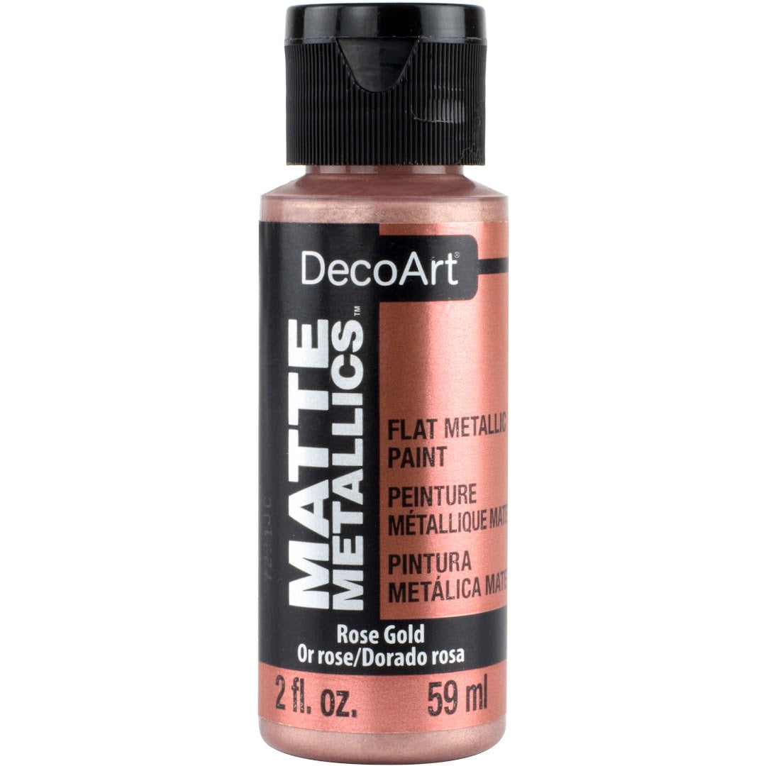 DecoArt Matte Metallics rose gold acrylic paint in a 2 oz bottle, showcasing its smooth, matte metallic finish.